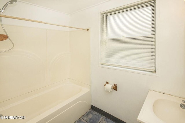 full bath featuring tile patterned flooring,  shower combination, and a sink