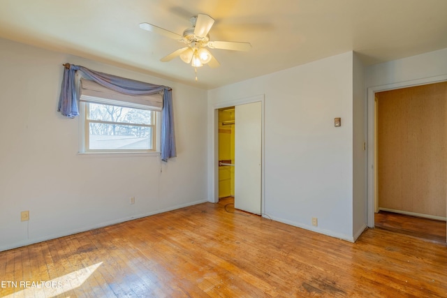 unfurnished bedroom featuring a closet, ceiling fan, baseboards, and light wood-style floors