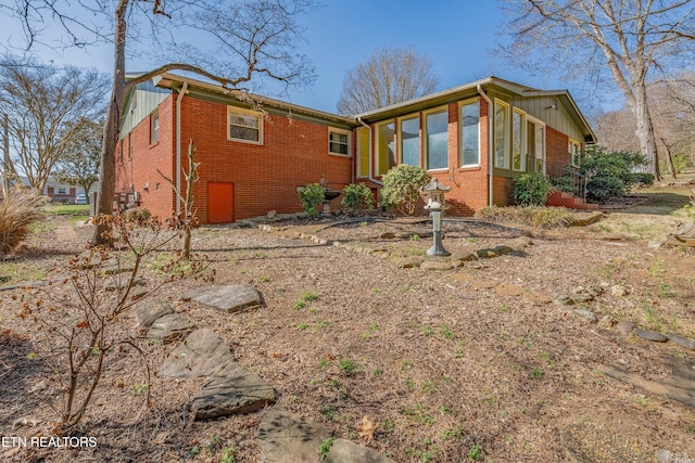 view of property exterior with brick siding