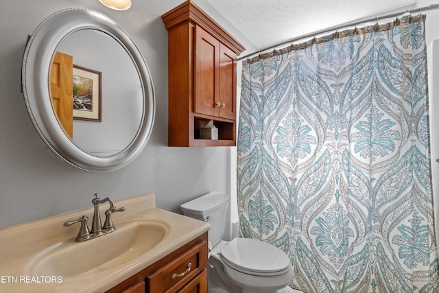 full bath featuring curtained shower, a textured ceiling, toilet, and vanity