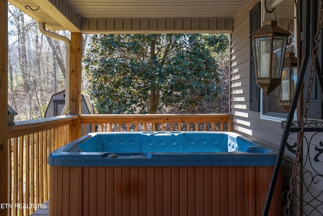 wooden terrace with a hot tub