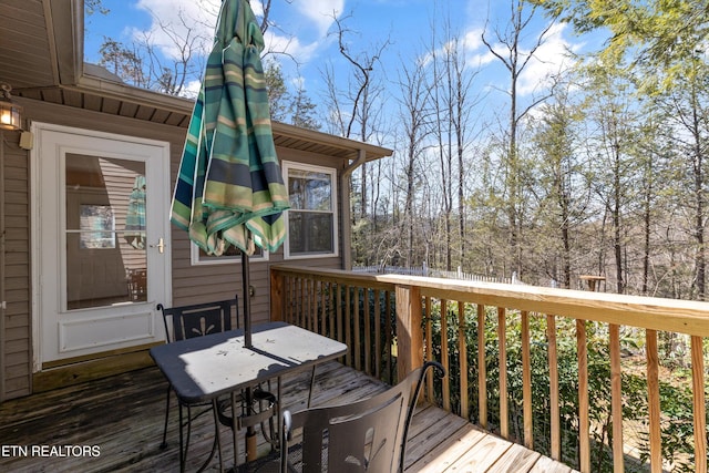 deck with outdoor dining area