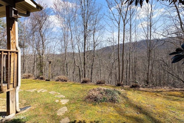 view of yard with a view of trees