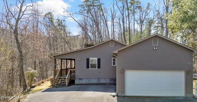 view of front of home with driveway and a garage