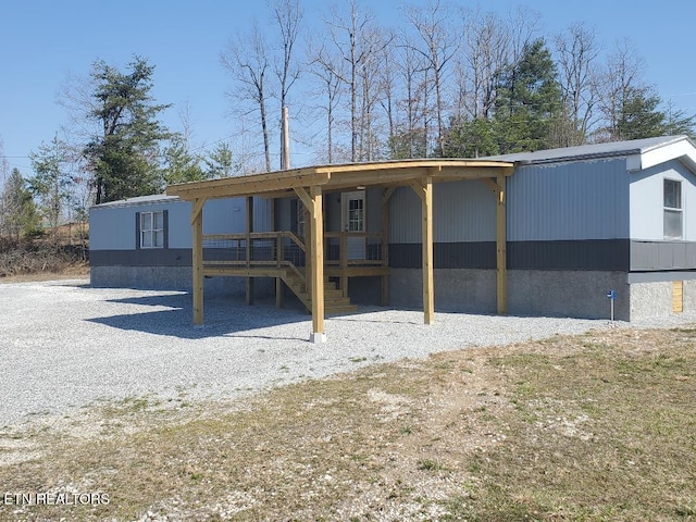 rear view of property with a carport