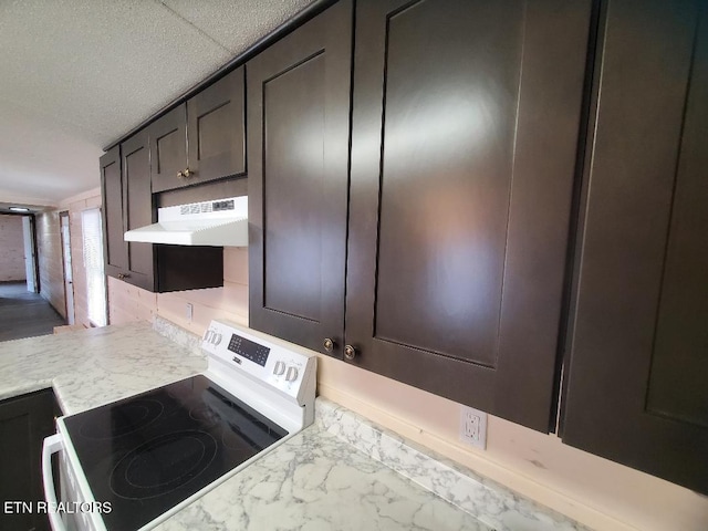 kitchen featuring under cabinet range hood, electric range oven, and light countertops