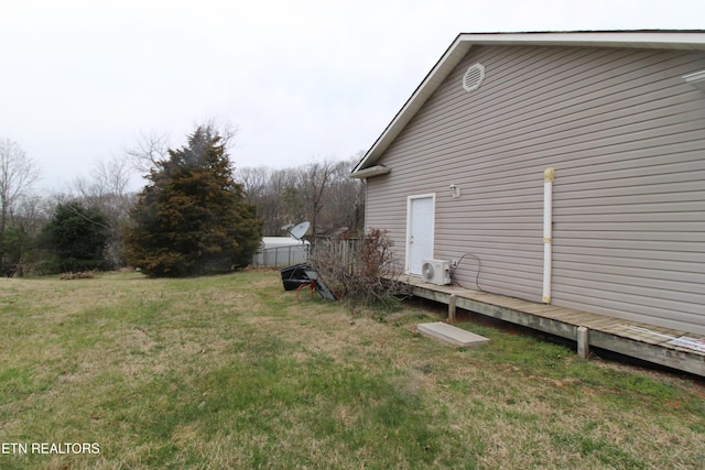 view of property exterior featuring a yard and fence