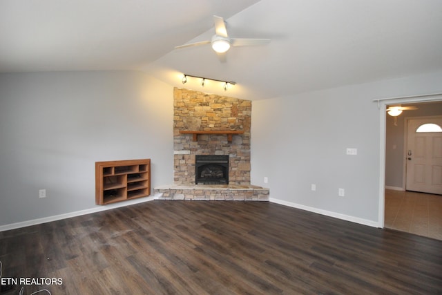 unfurnished living room with vaulted ceiling, wood finished floors, a ceiling fan, and baseboards