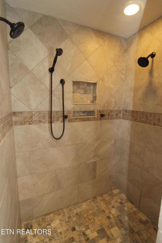 full bathroom with a tile shower