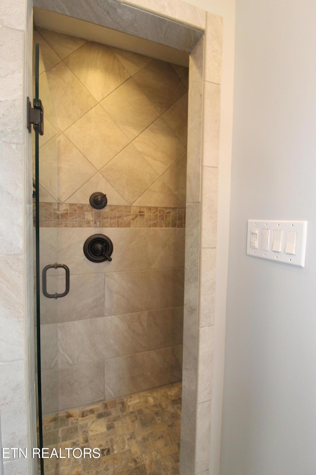 bathroom featuring a stall shower