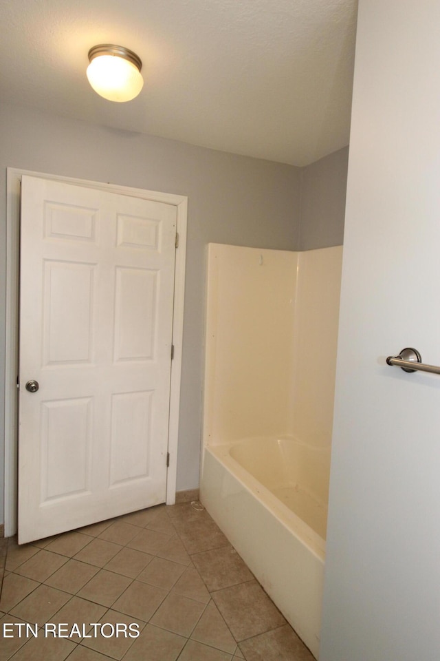 full bath with tile patterned floors, a bath, and a shower