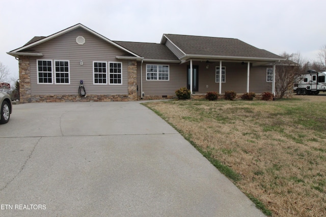 ranch-style house featuring a porch, a front lawn, and roof with shingles