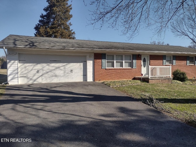 single story home with brick siding, driveway, and an attached garage