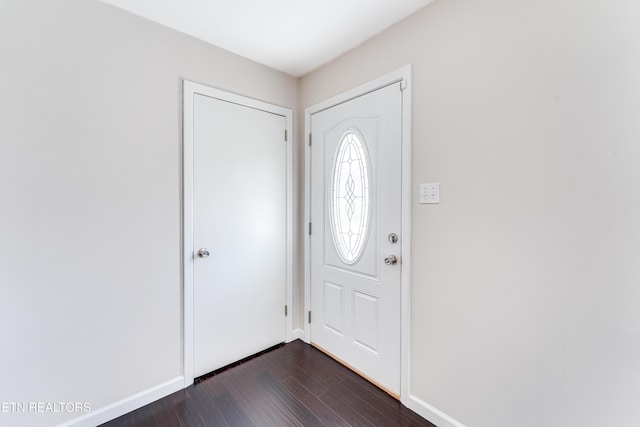 entrance foyer with baseboards and dark wood-style floors