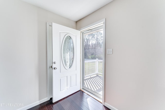 entrance foyer featuring baseboards and dark wood-style flooring