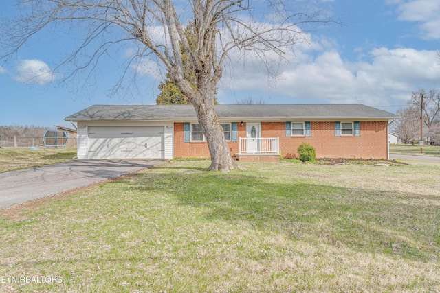 ranch-style house featuring a front lawn, an attached garage, brick siding, and driveway