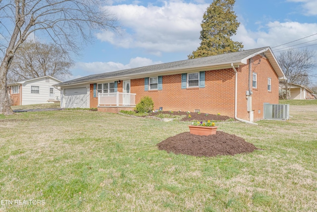 ranch-style home with a garage, brick siding, central AC unit, and a front yard