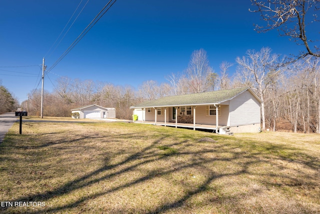 view of front of home featuring a garage, a porch, an outdoor structure, a front yard, and crawl space