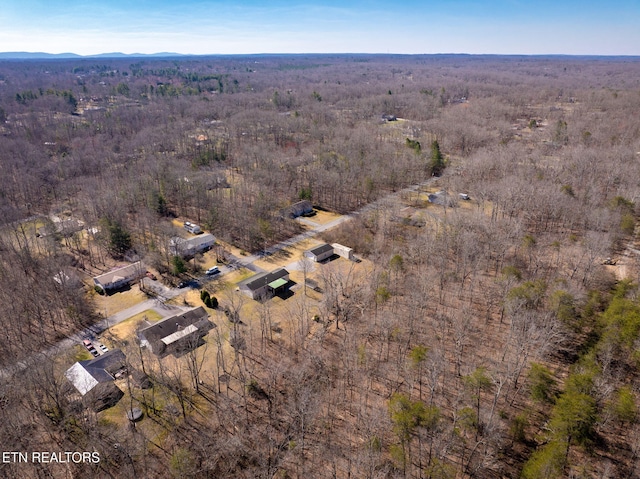 birds eye view of property featuring a wooded view