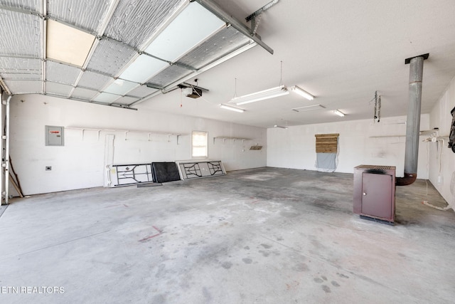 garage featuring electric panel and a garage door opener