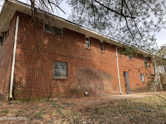 view of side of home featuring brick siding