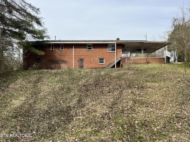 rear view of property featuring brick siding