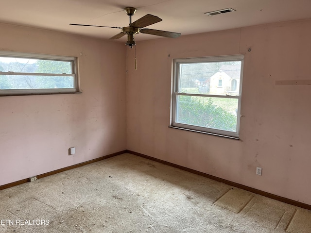 unfurnished room featuring visible vents, baseboards, and a ceiling fan