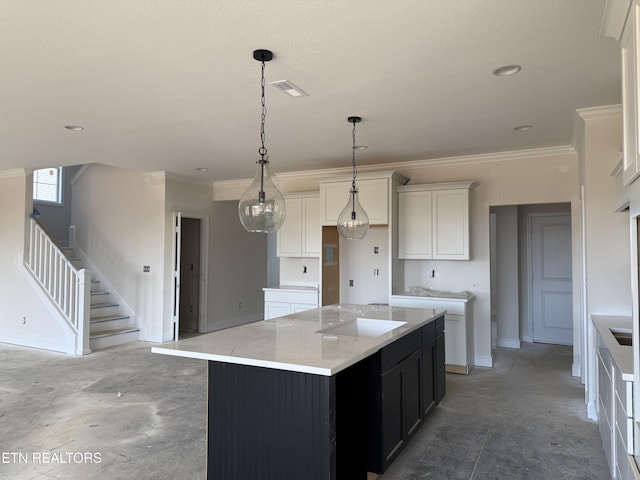 kitchen featuring a center island, concrete floors, ornamental molding, white cabinetry, and a sink