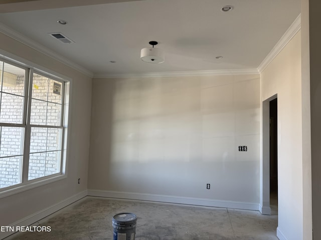 spare room with crown molding, baseboards, and visible vents