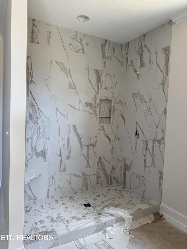 full bath with a marble finish shower