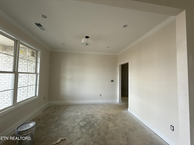 empty room with visible vents, concrete floors, baseboards, and ornamental molding