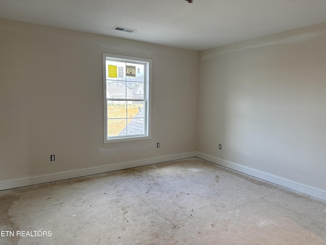 empty room featuring baseboards and visible vents