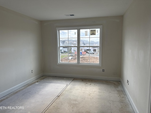 empty room featuring baseboards and visible vents