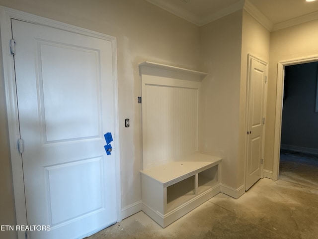 mudroom featuring crown molding, unfinished concrete flooring, and baseboards