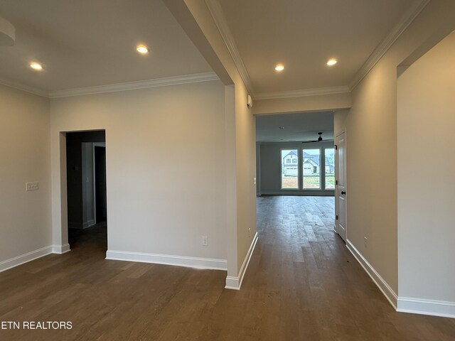 hallway featuring baseboards, dark wood-style floors, and crown molding