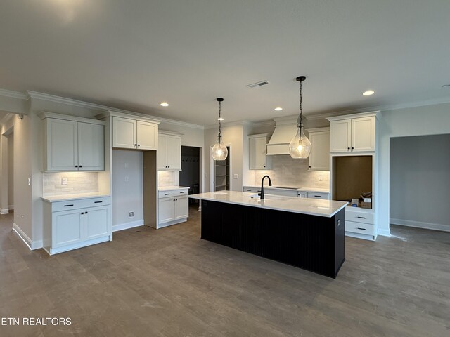kitchen with white cabinets, visible vents, ornamental molding, and tasteful backsplash