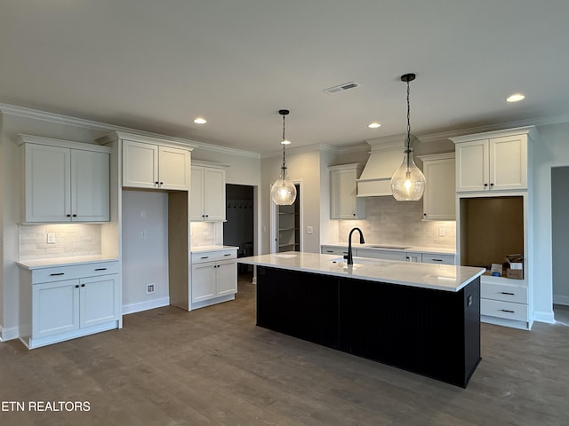kitchen featuring white cabinets, visible vents, backsplash, and ornamental molding