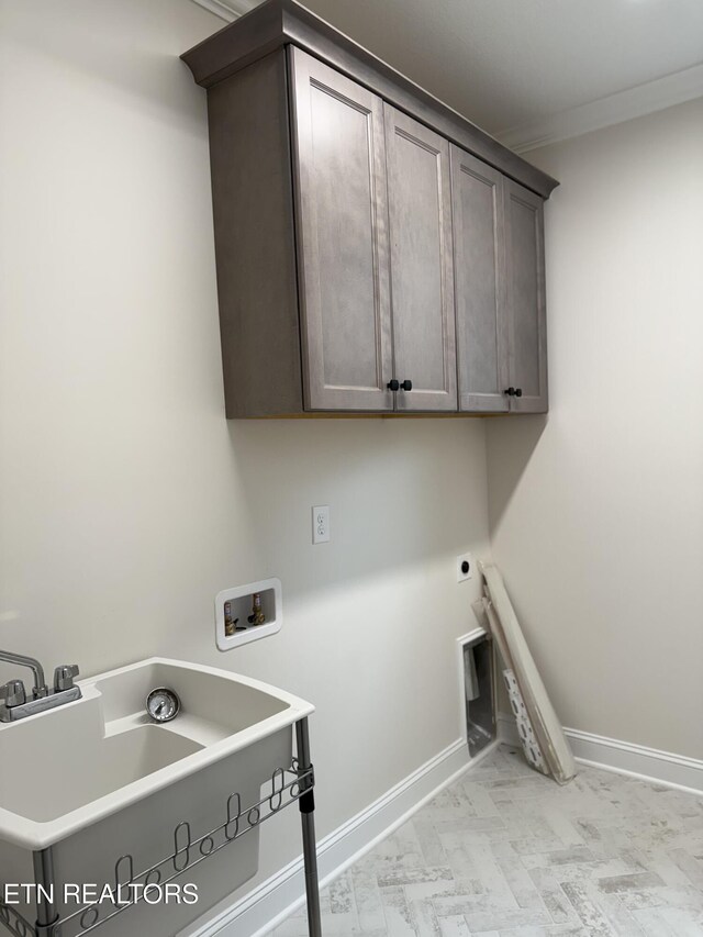 laundry room featuring a sink, hookup for an electric dryer, baseboards, washer hookup, and cabinet space