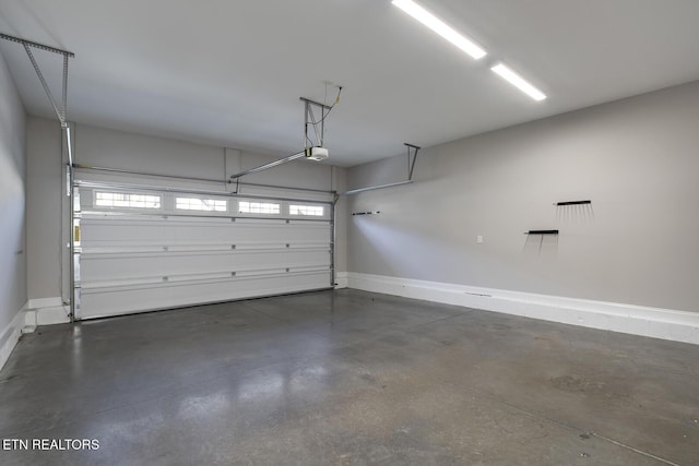 garage featuring baseboards and a garage door opener