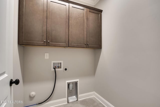 clothes washing area with baseboards, gas dryer hookup, washer hookup, cabinet space, and electric dryer hookup