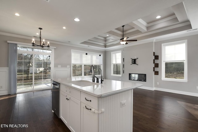 kitchen featuring visible vents, a sink, ornamental molding, a glass covered fireplace, and stainless steel dishwasher