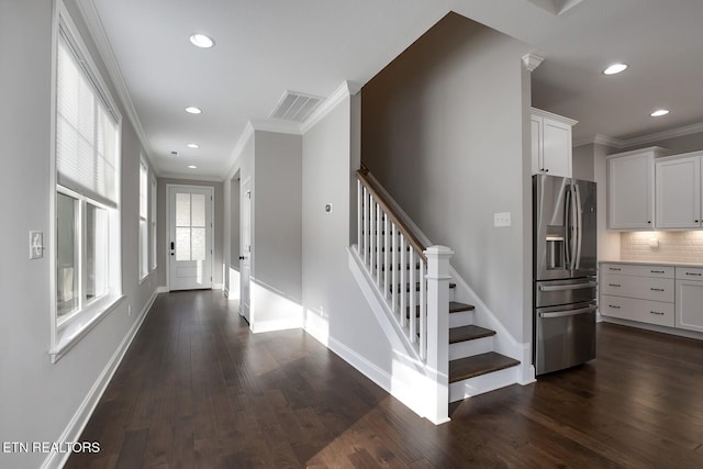 entrance foyer featuring visible vents, ornamental molding, recessed lighting, baseboards, and dark wood-style flooring