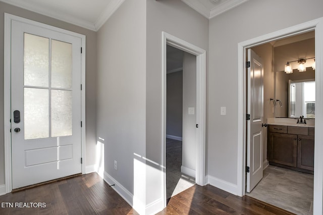 entryway featuring dark wood-type flooring, baseboards, and ornamental molding