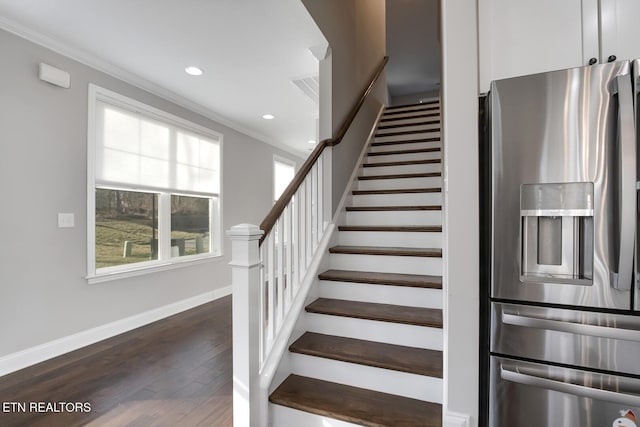 stairs featuring recessed lighting, wood finished floors, baseboards, and ornamental molding