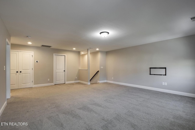 empty room with visible vents, recessed lighting, light colored carpet, and baseboards