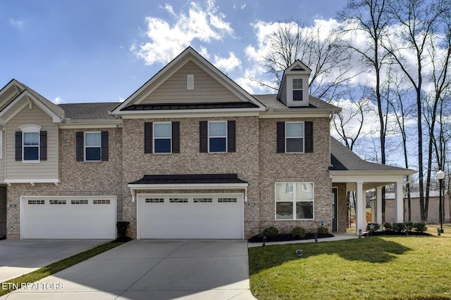 view of front of house featuring brick siding, an attached garage, and a front yard