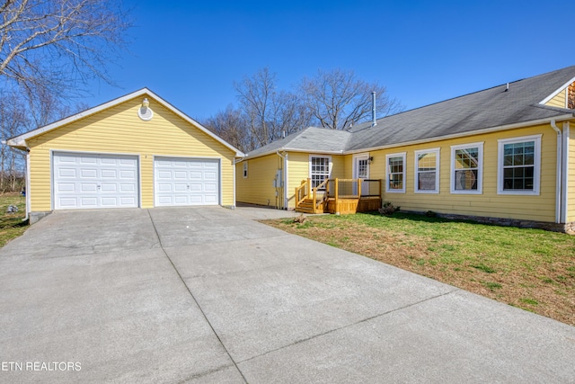 view of front of home with a front yard and a garage