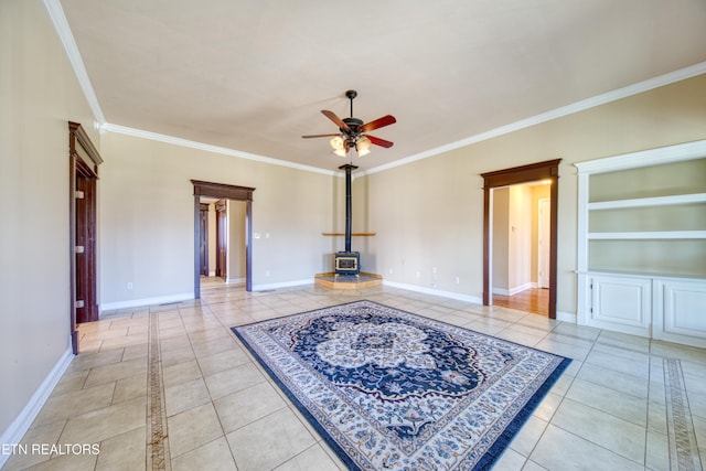 unfurnished living room featuring crown molding, a wood stove, light tile patterned floors, and ceiling fan