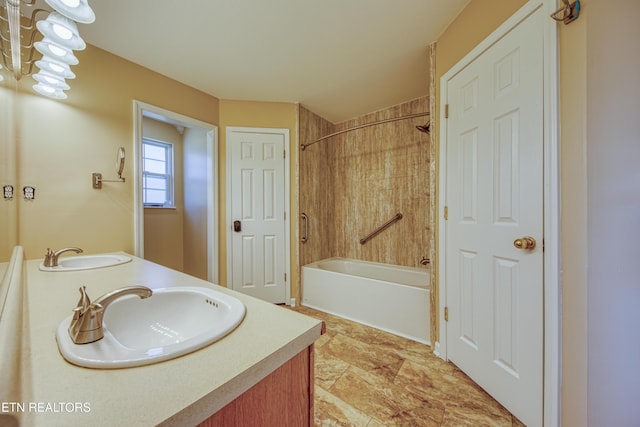 full bathroom featuring double vanity, shower / washtub combination, and a sink