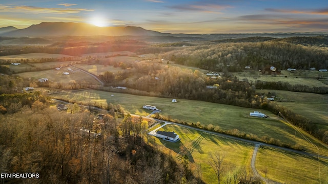 aerial view at dusk featuring a mountain view